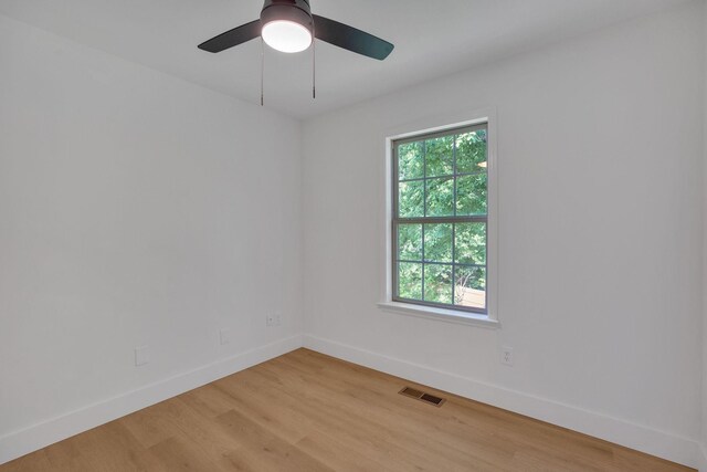 unfurnished room featuring baseboards, light wood finished floors, and ceiling fan