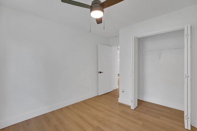 unfurnished bedroom with baseboards, light wood finished floors, a closet, and ceiling fan