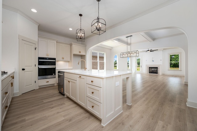 508 Gresham Ln, Murfreesboro, TN 37129 - kitchen with a sink, arched walkways, ceiling fan, light wood finished floors, and beam ceiling