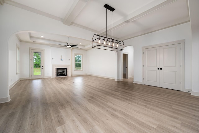 508 Gresham Ln, Murfreesboro, TN 37129 - unfurnished living room featuring arched walkways, ceiling fan, light wood-type flooring, beamed ceiling, and baseboards