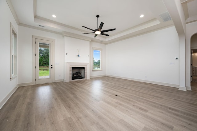 508 Gresham Ln, Murfreesboro, TN 37129 - unfurnished living room featuring a tray ceiling, a ceiling fan, arched walkways, a fireplace, and recessed lighting