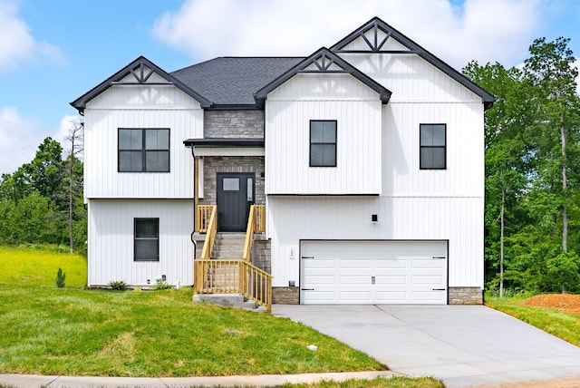 186 Dewberry Ct, Clarksville, TN 37042 - view of front facade featuring an attached garage, a front yard, stone siding, driveway, and roof with shingles