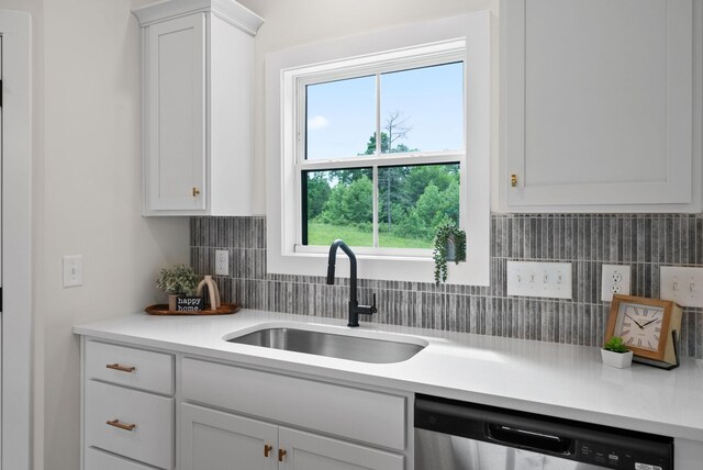 186 Dewberry Ct, Clarksville, TN 37042 - kitchen with stainless steel dishwasher, a sink, light countertops, and healthy amount of natural light