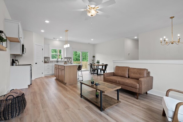 186 Dewberry Ct, Clarksville, TN 37042 - living room featuring light wood-style flooring, a chandelier, ceiling fan, and recessed lighting