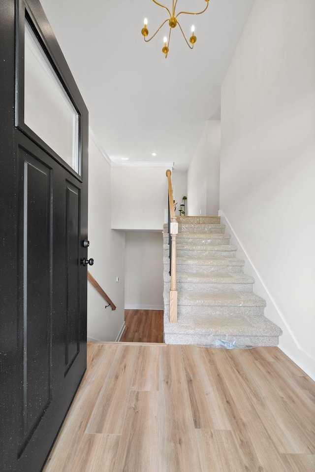 186 Dewberry Ct, Clarksville, TN 37042 - foyer entrance featuring wood finished floors, a chandelier, stairway, and baseboards