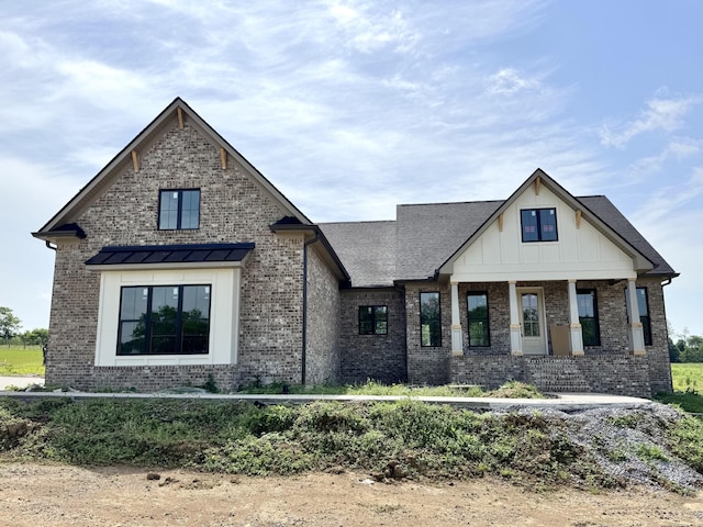 modern inspired farmhouse with board and batten siding and brick siding