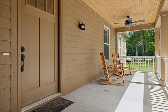 entrance to property with covered porch and ceiling fan