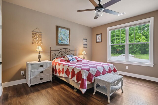 bedroom with baseboards, dark wood finished floors, and ceiling fan