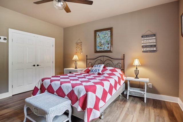 bedroom featuring a closet, wood finished floors, baseboards, and a ceiling fan