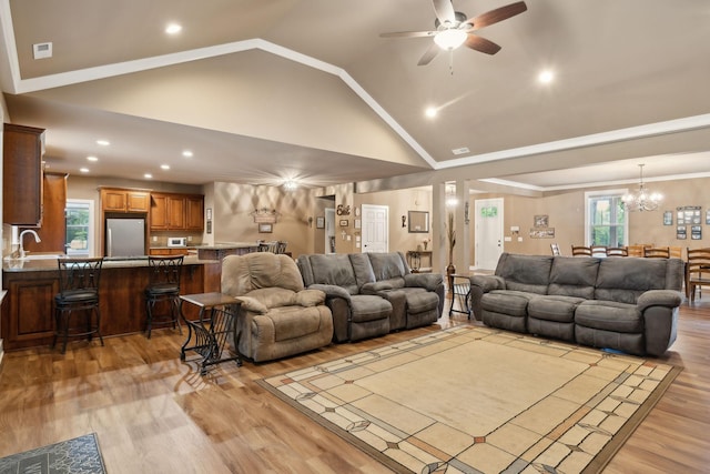 living area featuring a ceiling fan, light wood-type flooring, a chandelier, recessed lighting, and high vaulted ceiling