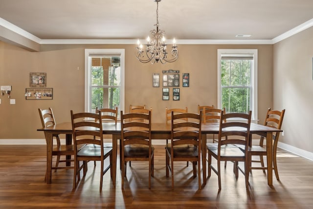 dining room with dark wood-style flooring, crown molding, baseboards, and a chandelier