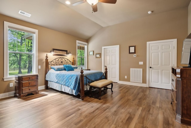 bedroom featuring lofted ceiling, baseboards, wood finished floors, and a ceiling fan