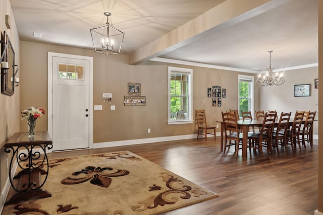dining area featuring a chandelier, wood finished floors, and baseboards