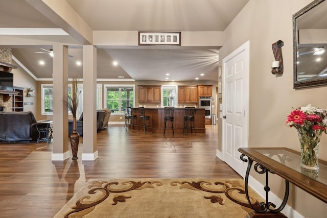 entryway featuring dark wood-style flooring, a ceiling fan, and baseboards