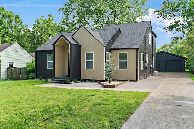 view of front of home featuring roof with shingles, an outdoor structure, a detached garage, and central air condition unit
