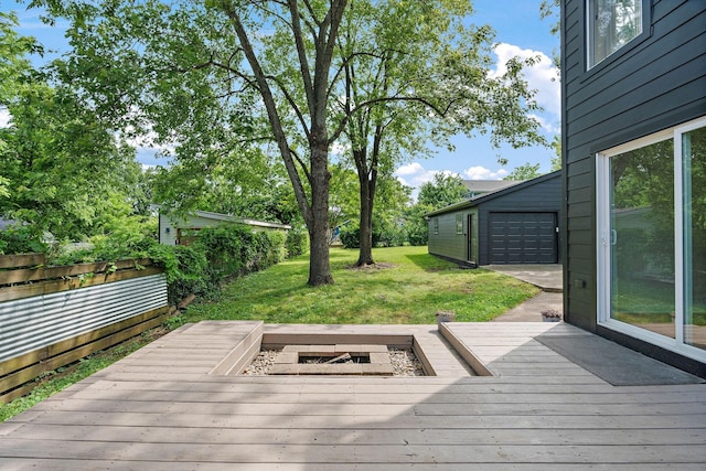wooden deck with a lawn and a detached garage