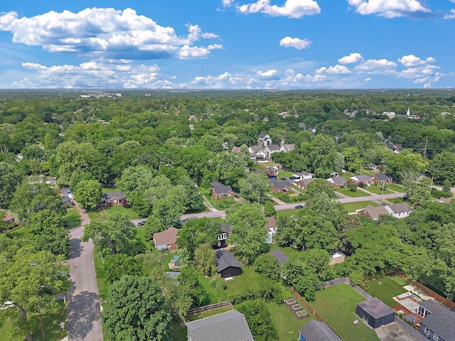 aerial view of residential area featuring a forest