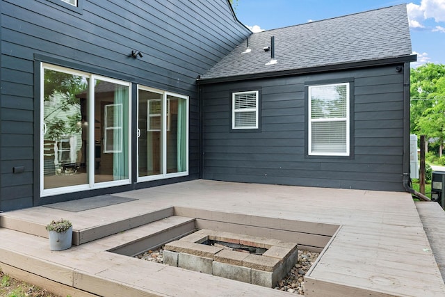 view of patio / terrace featuring a wooden deck and an outdoor fire pit
