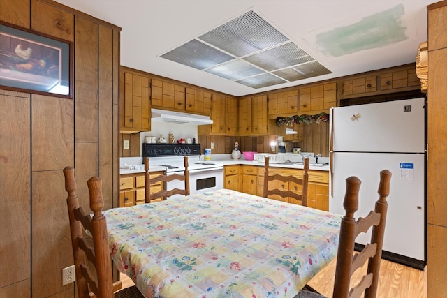 1326 Holly Tree Gap Rd, Brentwood, TN 37027 - kitchen with white appliances, under cabinet range hood, light countertops, range hood, and brown cabinetry
