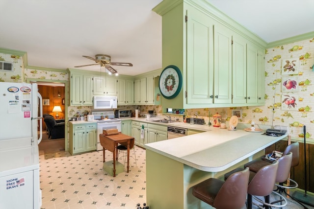 1326 Holly Tree Gap Rd, Brentwood, TN 37027 - kitchen featuring white appliances, a peninsula, green cabinetry, light countertops, and ornamental molding