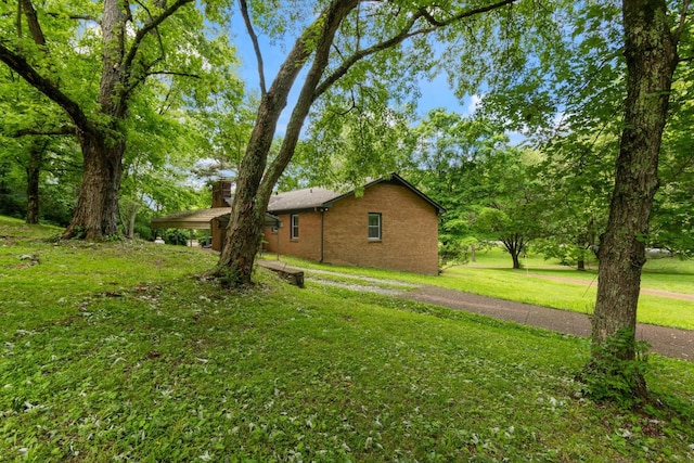 1326 Holly Tree Gap Rd, Brentwood, TN 37027 - view of side of property featuring a yard and brick siding