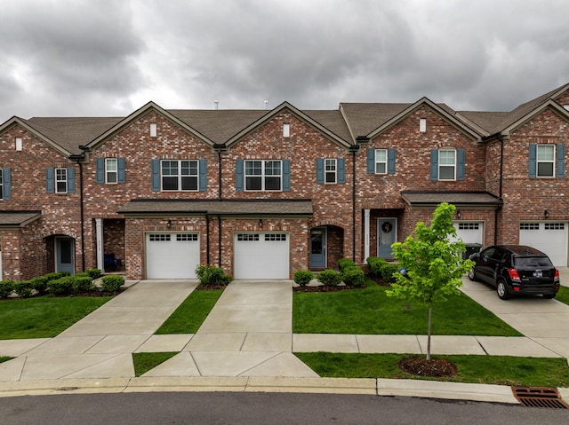 3021 Duvall Dr, Gallatin, TN 37066 - multi unit property featuring an attached garage, driveway, a front yard, and brick siding