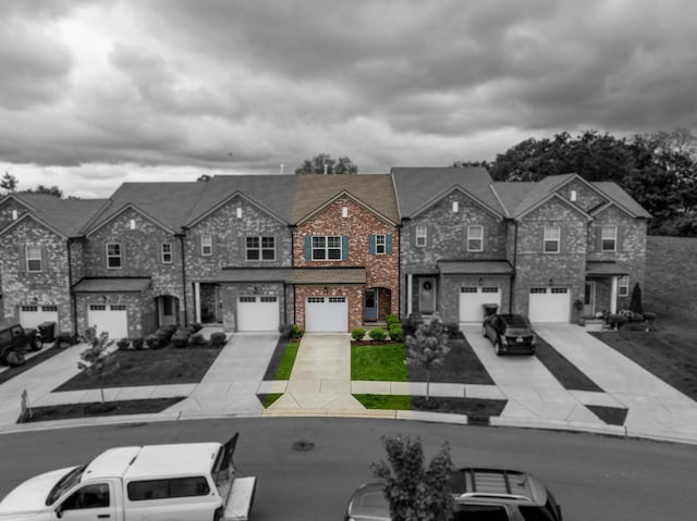 3021 Duvall Dr, Gallatin, TN 37066 - view of front of house with an attached garage, a residential view, driveway, and brick siding