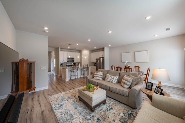 3021 Duvall Dr, Gallatin, TN 37066 - living room featuring light wood-style floors, baseboards, and recessed lighting