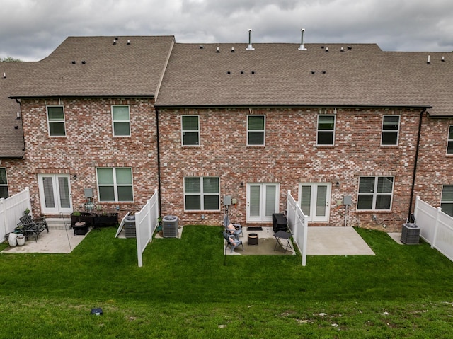 3021 Duvall Dr, Gallatin, TN 37066 - back of property featuring a shingled roof, central AC unit, and a patio area