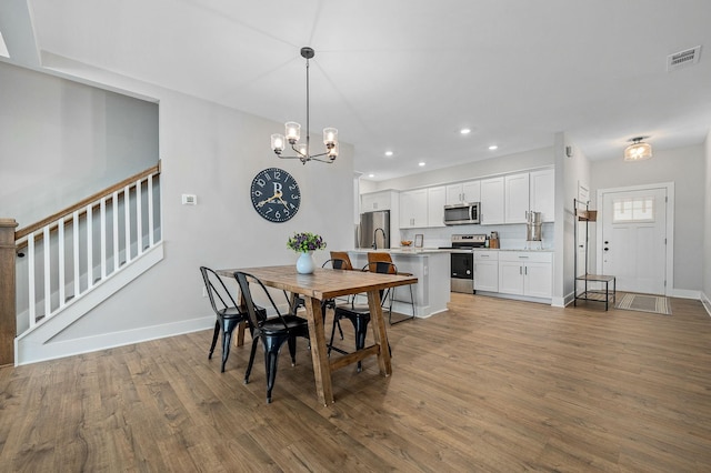 2617 Leawood Ct, Murfreesboro, TN 37128 - dining space featuring wood finished floors, a chandelier, stairway, recessed lighting, and baseboards
