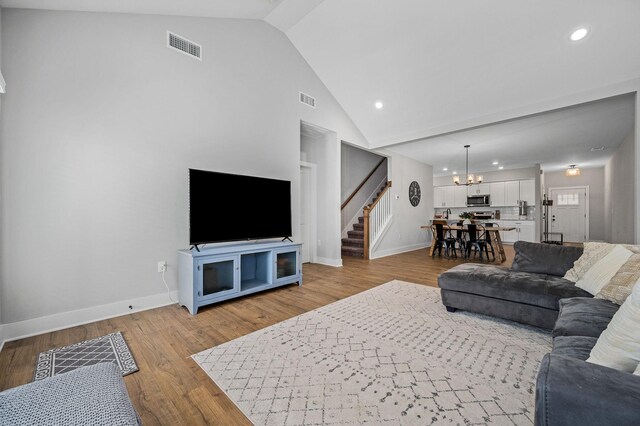 2617 Leawood Ct, Murfreesboro, TN 37128 - living room with stairway, baseboards, a chandelier, high vaulted ceiling, and recessed lighting