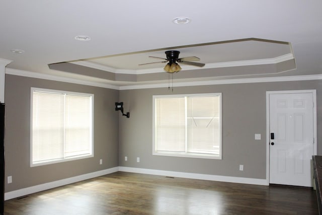 430 Gobble St, Lawrenceburg, TN 38464 - empty room with a raised ceiling, ceiling fan, crown molding, and dark wood finished floors