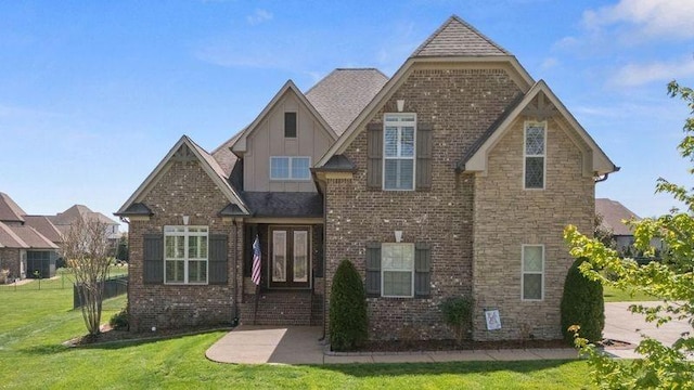 503 Carriage Ln, Lebanon, TN 37087 - craftsman house with a front lawn, board and batten siding, and brick siding