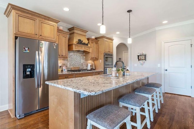 503 Carriage Ln, Lebanon, TN 37087 - kitchen featuring stainless steel appliances, arched walkways, a sink, dark wood finished floors, and an island with sink