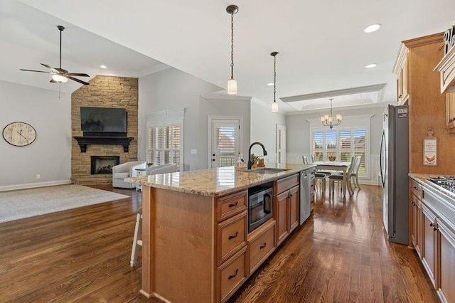 503 Carriage Ln, Lebanon, TN 37087 - kitchen with appliances with stainless steel finishes, a sink, a stone fireplace, a chandelier, and ceiling fan