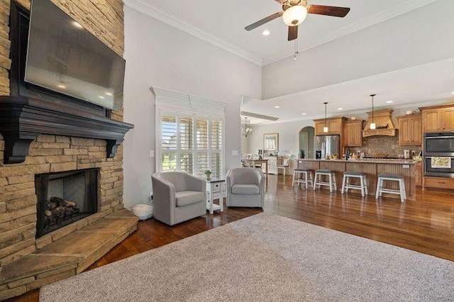 503 Carriage Ln, Lebanon, TN 37087 - living room with a ceiling fan, dark wood-type flooring, a stone fireplace, crown molding, and recessed lighting