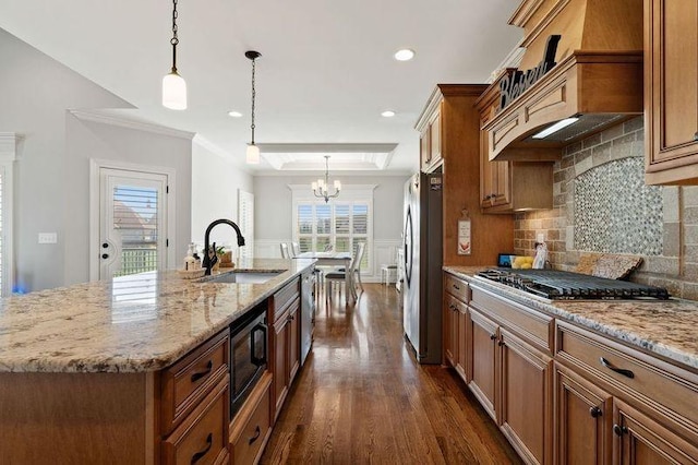 503 Carriage Ln, Lebanon, TN 37087 - kitchen with a sink, stainless steel appliances, brown cabinetry, a chandelier, and dark wood finished floors