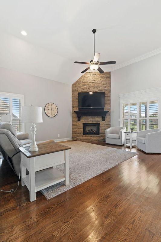 503 Carriage Ln, Lebanon, TN 37087 - living room featuring a ceiling fan, a stone fireplace, wood finished floors, and ornamental molding