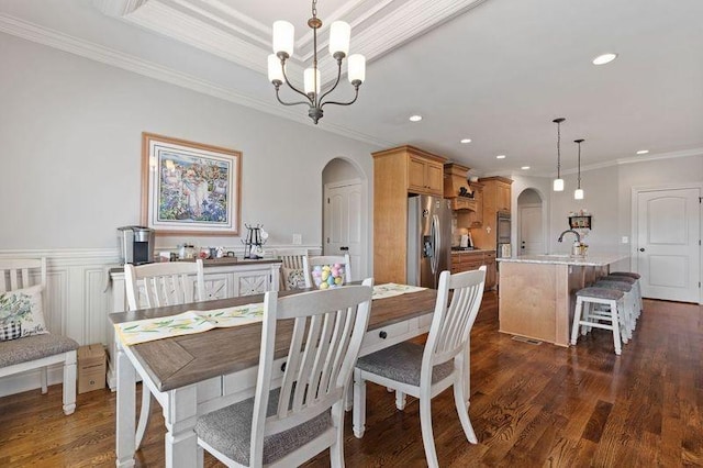 503 Carriage Ln, Lebanon, TN 37087 - dining room with arched walkways, ornamental molding, recessed lighting, a chandelier, and dark wood-type flooring