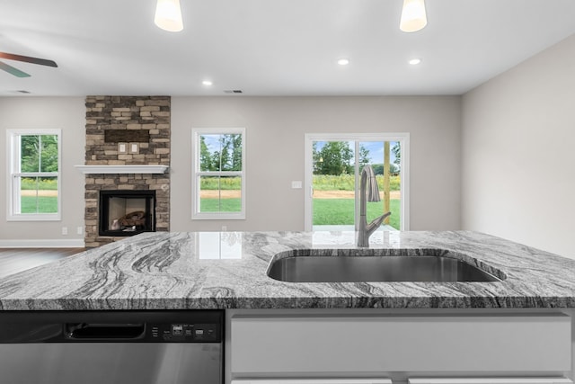 373 Galway Dr, Clarksville, TN 37042 - kitchen with stainless steel dishwasher, a sink, open floor plan, light stone countertops, and a ceiling fan