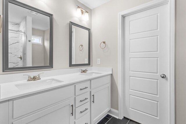 373 Galway Dr, Clarksville, TN 37042 - bathroom with double vanity, baseboards, a marble finish shower, and tile patterned floors