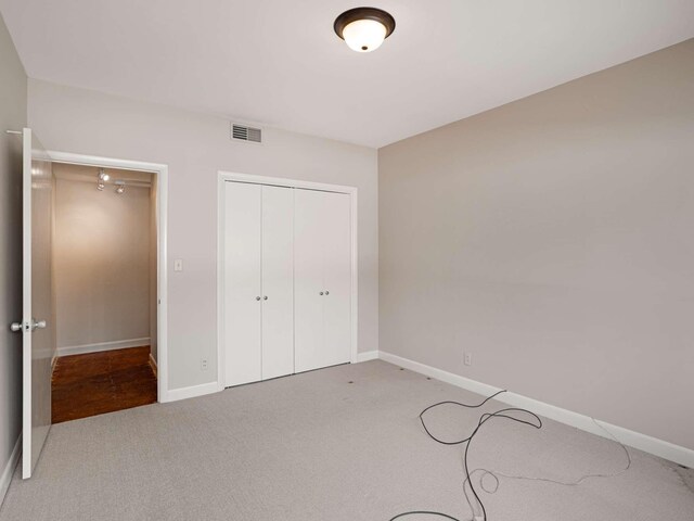 4200 W End Ave Unit 203, Nashville, TN 37205 - unfurnished bedroom featuring carpet, baseboards, and a closet