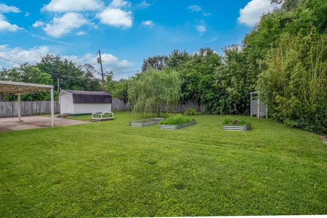 3008 Mcintire Dr, Columbia, TN 38401 - view of yard featuring a garden, a shed, an outdoor structure, a patio, and a detached carport