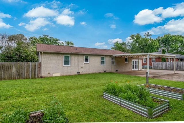 3008 Mcintire Dr, Columbia, TN 38401 - back of house featuring crawl space, a patio, brick siding, a garden, and concrete driveway