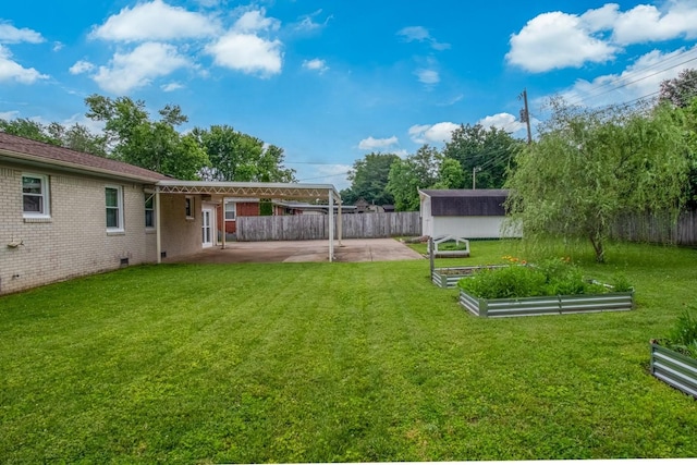 3008 Mcintire Dr, Columbia, TN 38401 - view of yard featuring a storage unit, a patio, a vegetable garden, and an outdoor structure