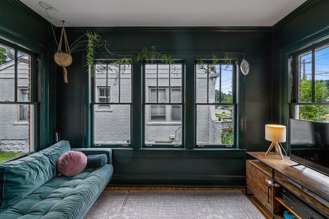 living room with ornamental molding and wood finished floors