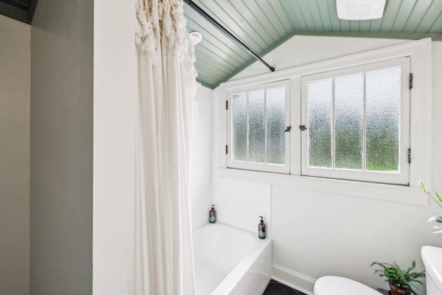 full bathroom featuring plenty of natural light, toilet, lofted ceiling, shower / tub combo, and wood ceiling