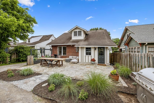 back of property with brick siding, fence, a patio, an outdoor hangout area, and a shingled roof