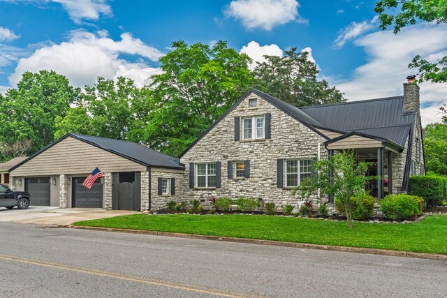 813 Swanson Blvd, Fayetteville, TN 37334 - view of front of house with stone siding, a chimney, driveway, and a front lawn