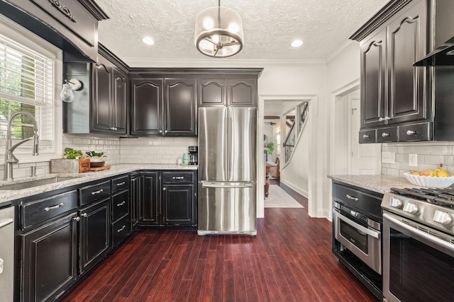 813 Swanson Blvd, Fayetteville, TN 37334 - kitchen featuring appliances with stainless steel finishes, a sink, a textured ceiling, light stone countertops, and backsplash